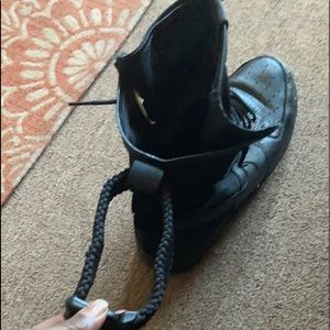 Black size 13 Air Force with adjustable straps in the rear of sneakers